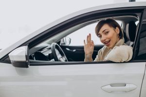 woman sitting car car showroom